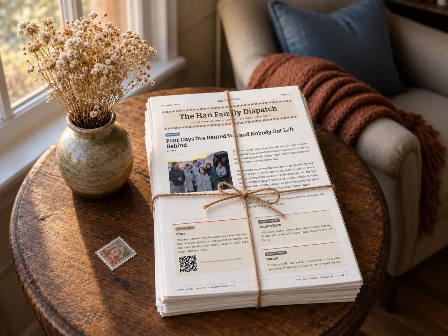 A stack of past printed newsletter issues tied with twine on a side table by a window